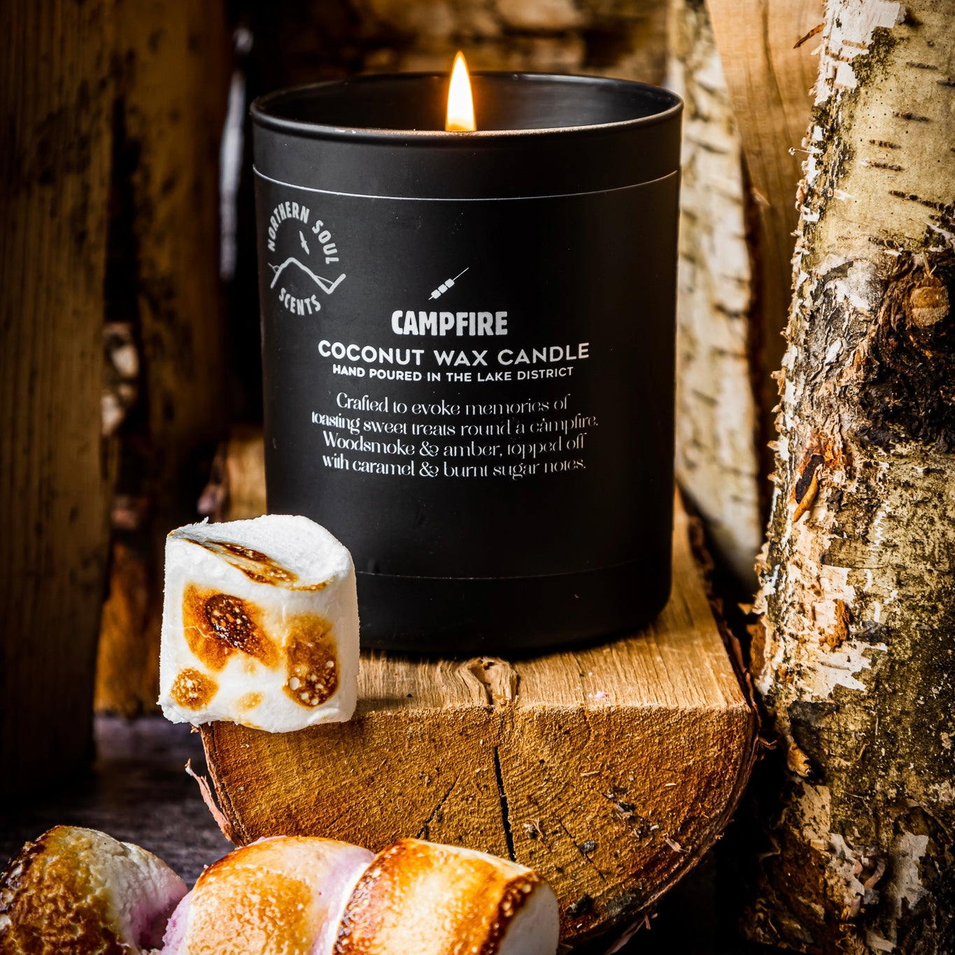 Campfire scented candle in a matte black opaque candle jar with a tent and campfire design and premium quality labelling for a sleek look. Perfect for gifting.