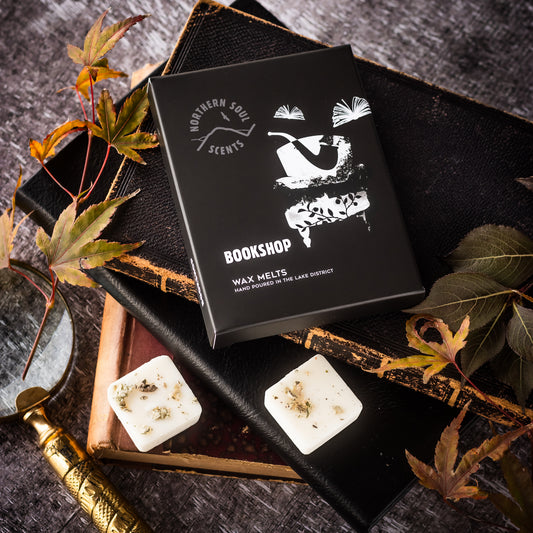 Delight in the nostalgic charm of a bookshop with these eco-friendly wax melts. Encased in a plastic-free wax paper bag and adorned with a cardboard sleeve featuring a quirky book and armchair design on the front, experience the captivating aroma of well-loved books, cozy armchairs, and a hint of vanilla. Immerse yourself in the inviting ambiance of your favorite reading nook with these delightful wax melts.