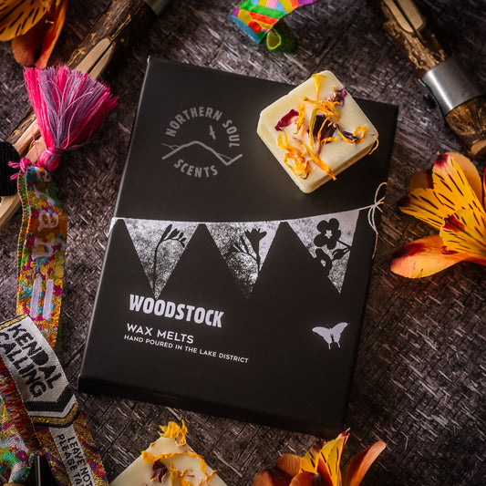 Wax melts to channel the spirit of music and celebration with these vibrant scented wax melts. Packaged in a plastic-free wax paper bag and enclosed in a cardboard sleeve adorned with a festive bunting design on the front, these melts capture the essence of the iconic Woodstock festival. Each wax cube is adorned with real dried flower petals, adding a touch of natural beauty.
