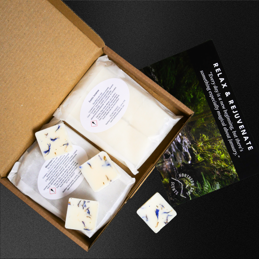 Example of wax melt subscription box with wax cubes shown in 2 different scents, topped with floral botanicals. 